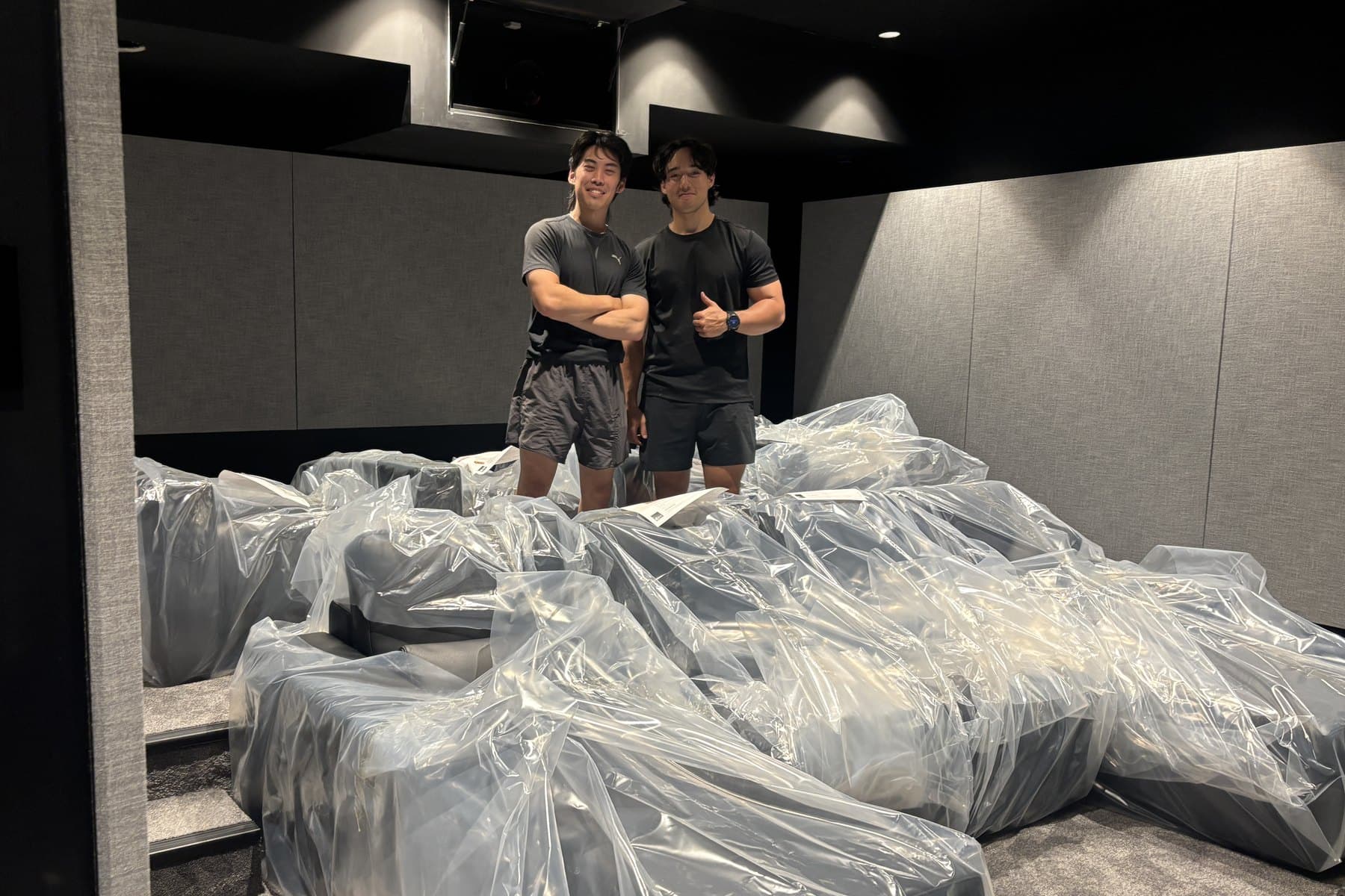 The Load Lounge team on a staging install, surrounded by wrapped furniture